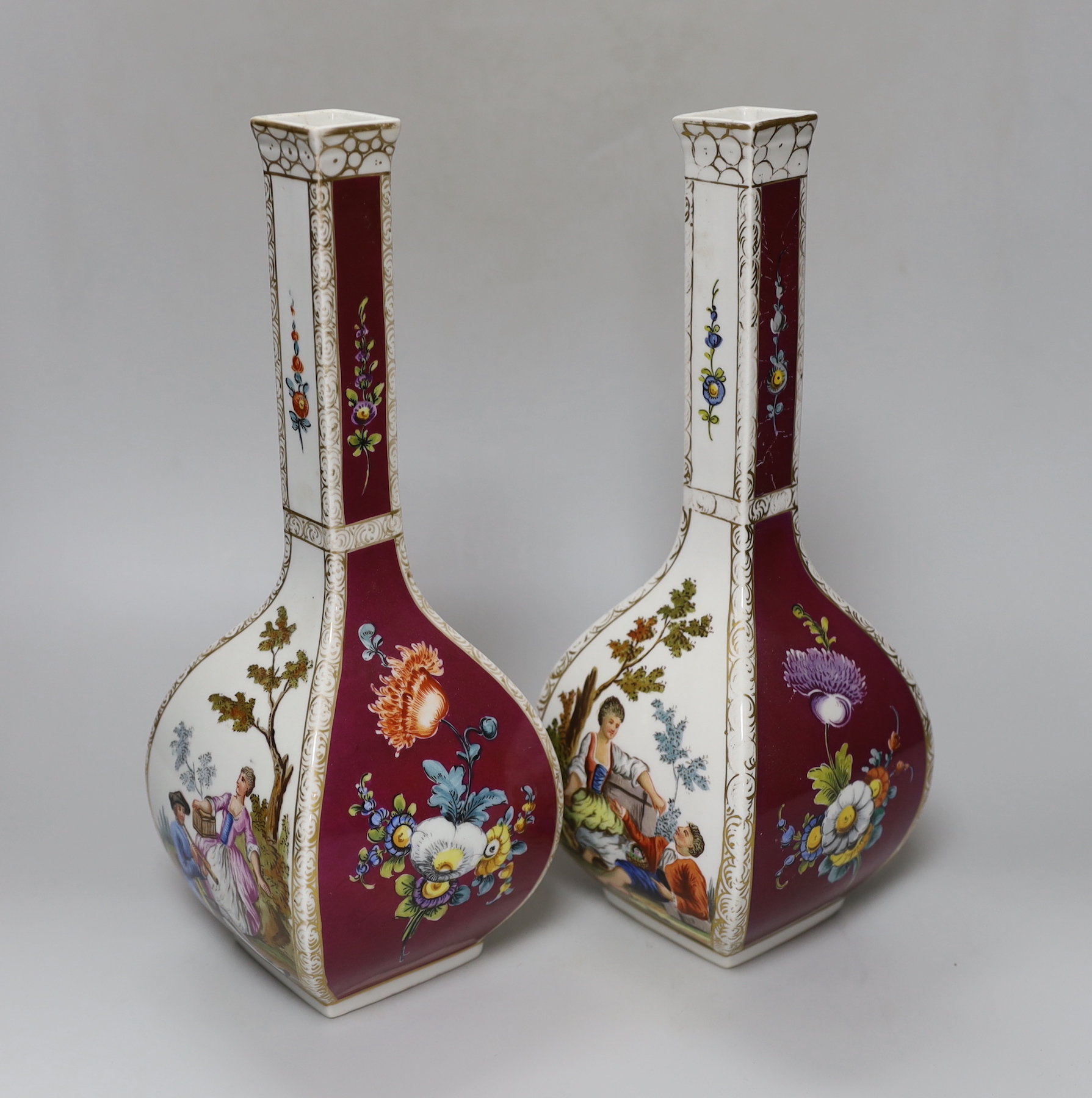 A pair of early 20th century Dresden square bottle vases, 31cm